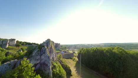 aerial flyover towards and around the ruins of the zamek ogrodzieniec medieval castle in in podzamcze near ogrodzieniec, poland