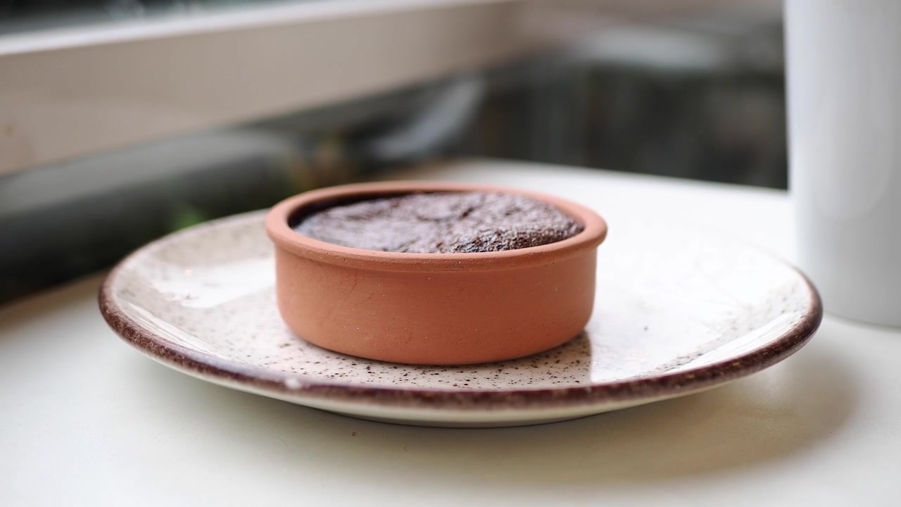 Moelleux au chocolat dans un pot en terre cuite sur une assiette