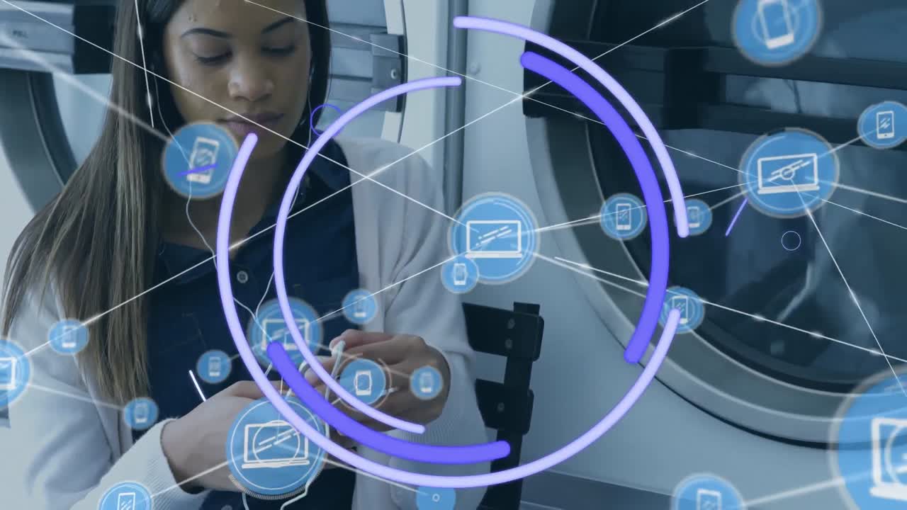 animación de una red de conexiones con iconos sobre una mujer biracial usando un teléfono inteligente en la lavandería