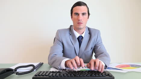 man typing on his computer