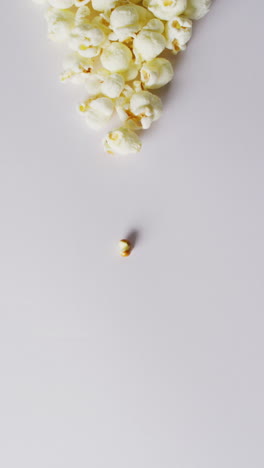 vertical video of close up of popcorn on white background