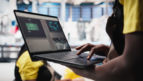 vertical video female technician using laptop to monitor solar panel manufacturing plant