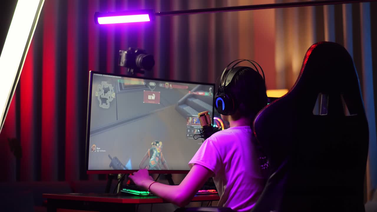 Back View Of Asian Girl Streamer Feeling Disappointed Fails Game Over On Personal Computer.  Live Stream Video Game, Desk Illuminated By Rgb Led Strip Light