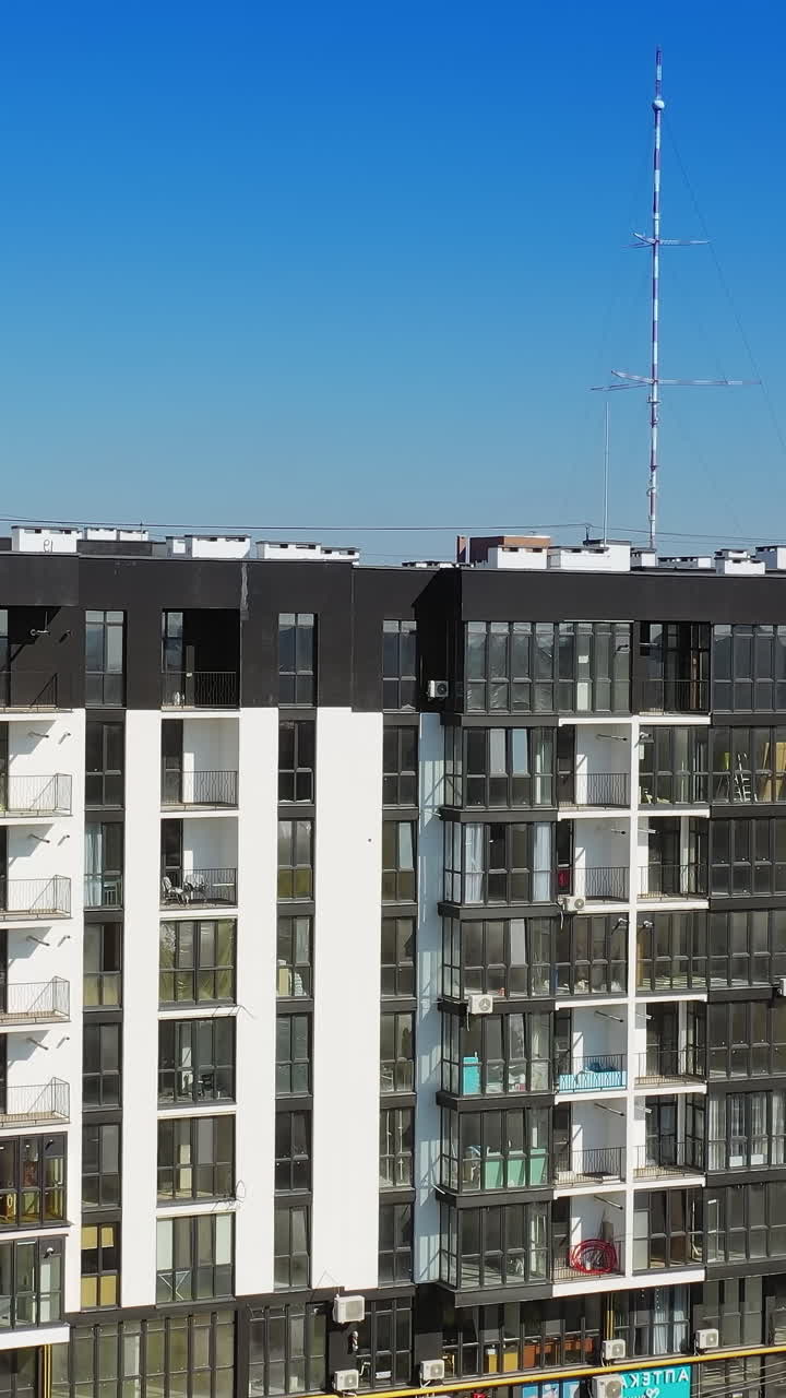 Modern residential area in city. Aerial view of contemporary apartment building with large windows