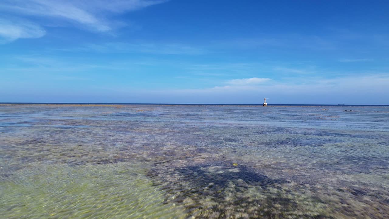 Dynamic aerial forward motion flying quickly above the shallow coral-filled waters of My Hoa Lagoon in Phan Rang, Vietnam.