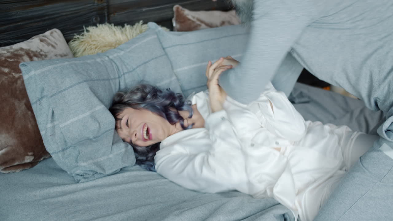 Happy Couple Playing in Bed