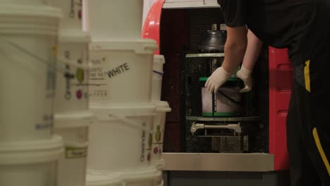 a worker mixes the material for puttying the walls in centrifuge