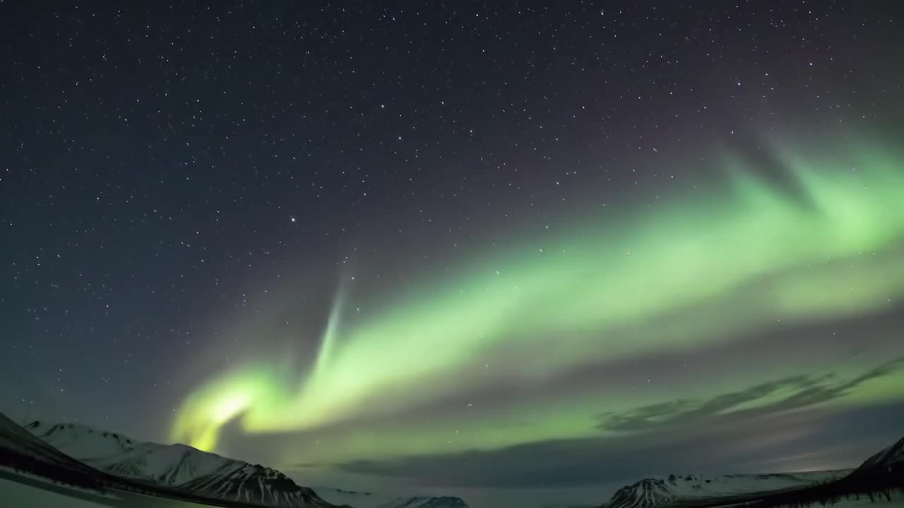 A brilliant display of the northern lights captivates viewers as vibrant green and purple hues dance across the starry night sky. This mesmerizing phenomenon occurs in a remote Arctic location.