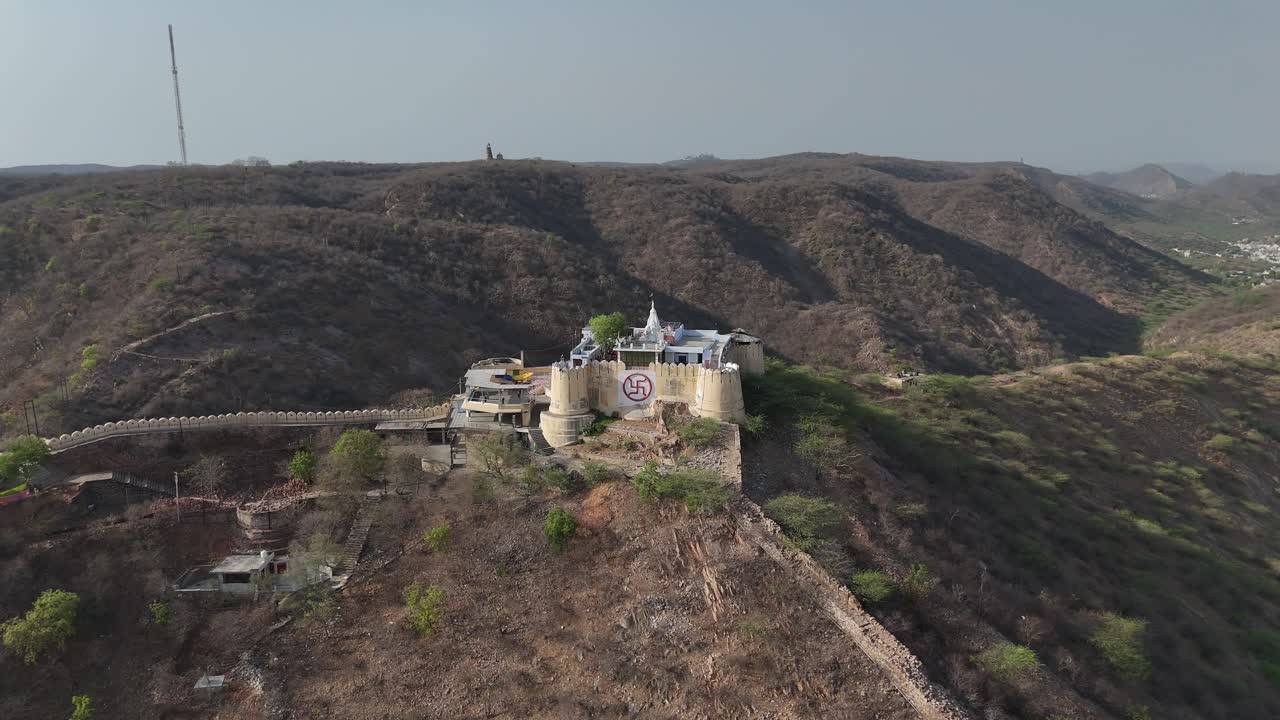 Scenic aerial shot of a massive fort wall stretching across rocky hills.