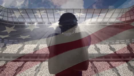 composite video of american flag over male rugby player against sports stadium