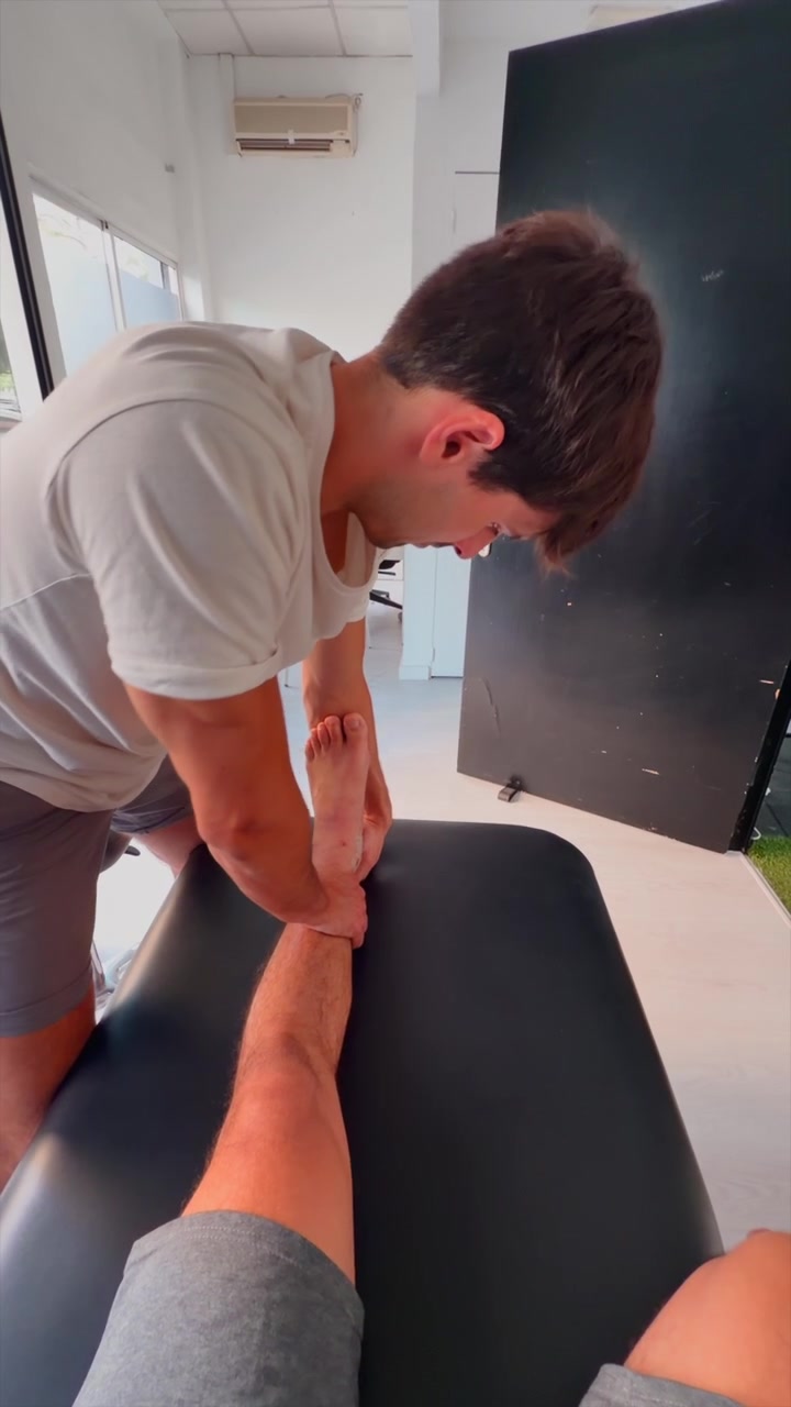 Physical Therapist Performing Ankle Mobilization on Patient