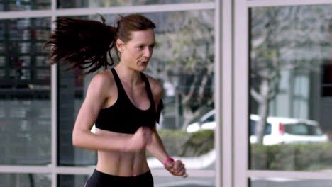 athletic running fitness woman in urban city