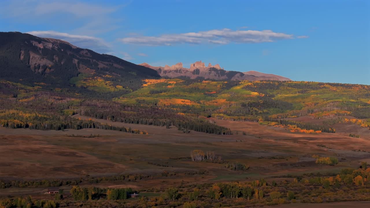 Scenic Fall autumn drive Mill Creek Ranch farm land Ohio Creek Valley Pass near Crested Butte Colorado Gunnison Country aerial drone Mill Castle rock landmark feature colorful Aspen trees forward pan