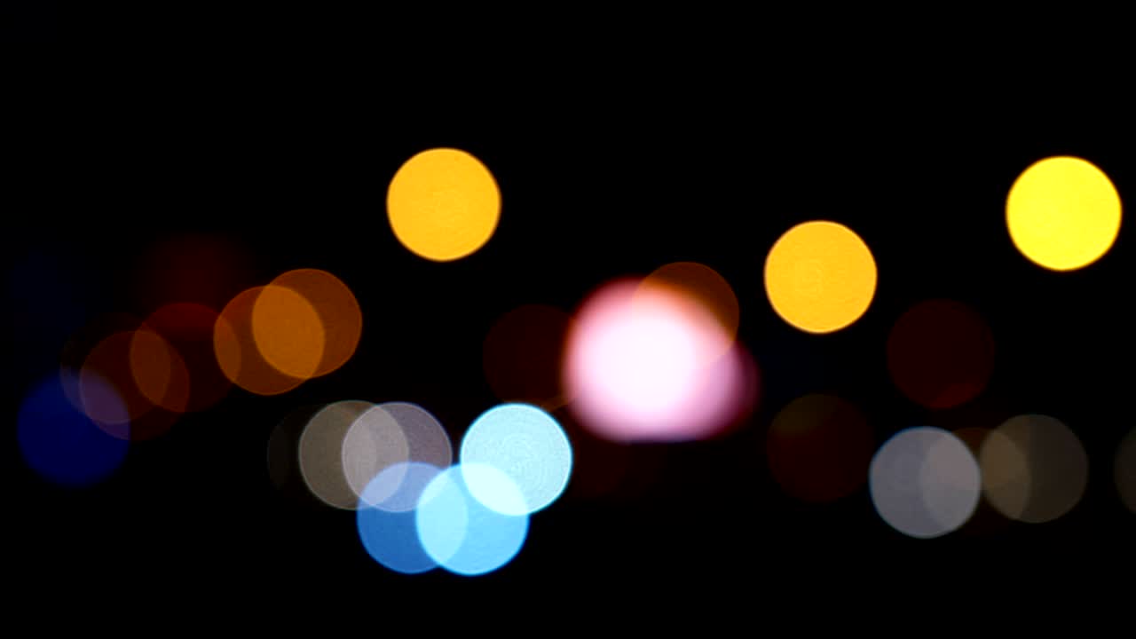 Defocused lights Los Angeles street abstract . City blur background. Moving bokeh circles of night traffic.