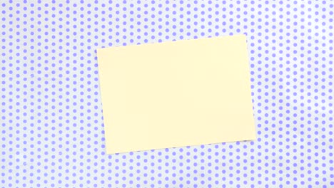 yellow piece of paper on a dotted background