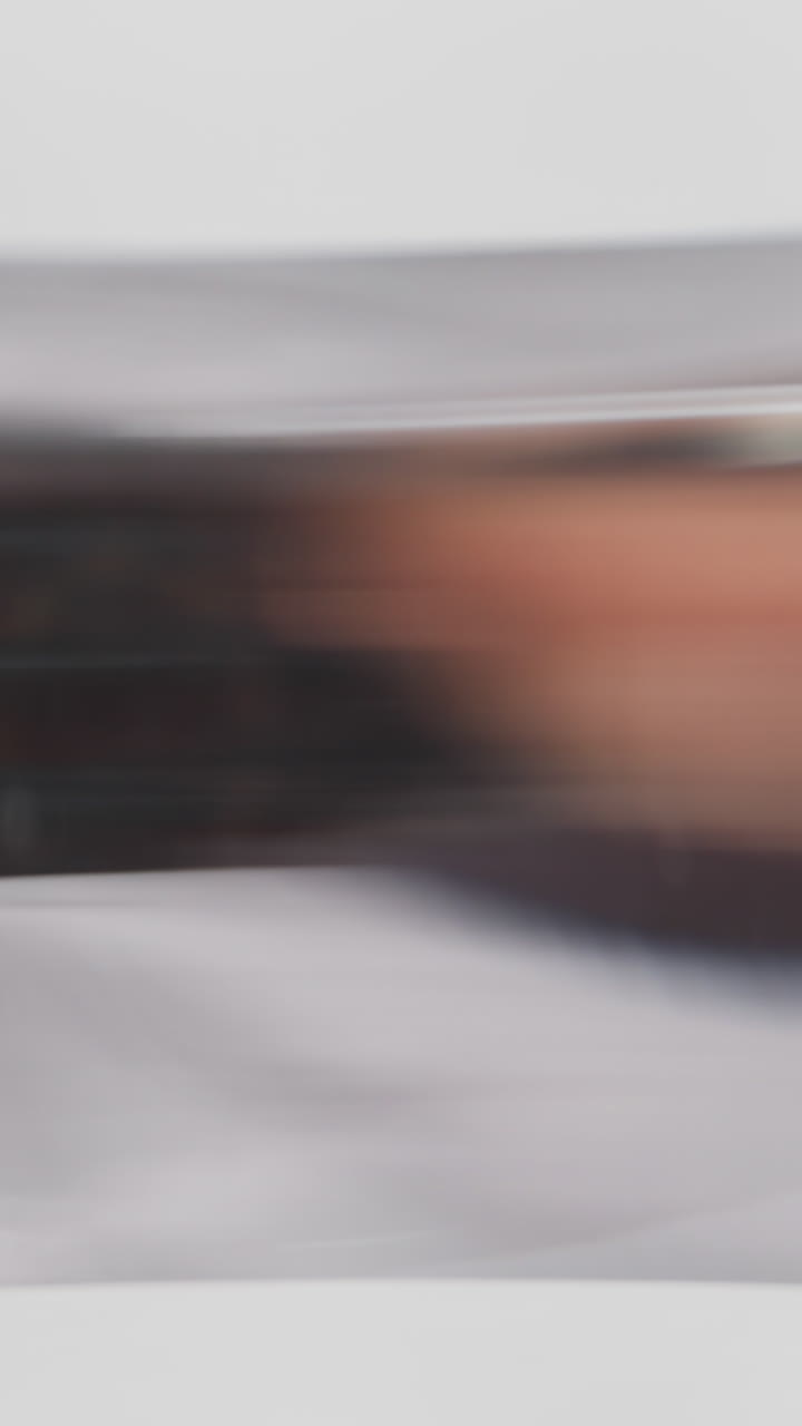 Skilled lady lab assistant with special face shield puts beaker onto table doing test slow motion. Probe lens footage of laboratory work macro view
