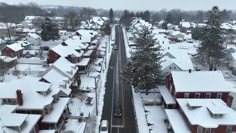 Cars-waiting-on-junction-in-snow-small-town-at-winter-snow