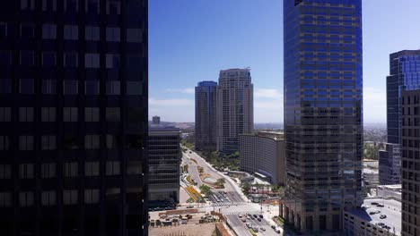 aerial dolly panning shot around skyscraper to reveal century city, california