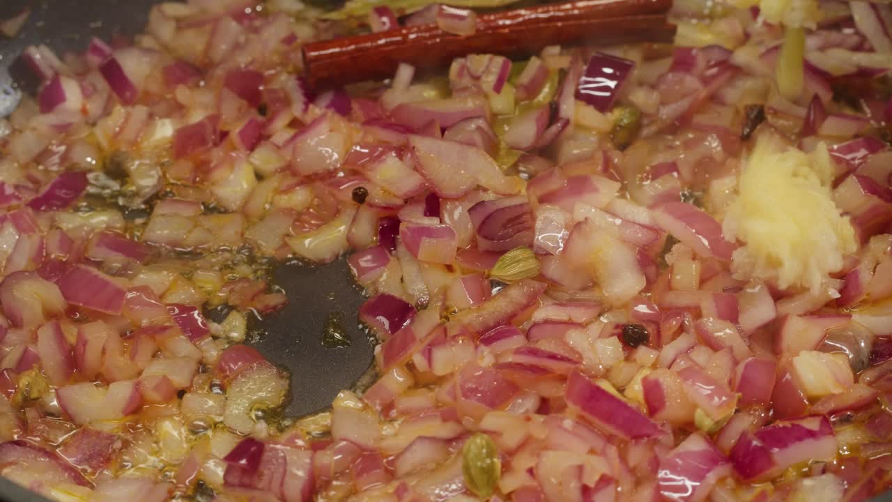 Cooking onions, ginger, and spices
