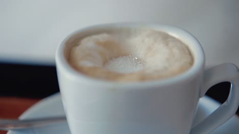 pouring sugar into a glass