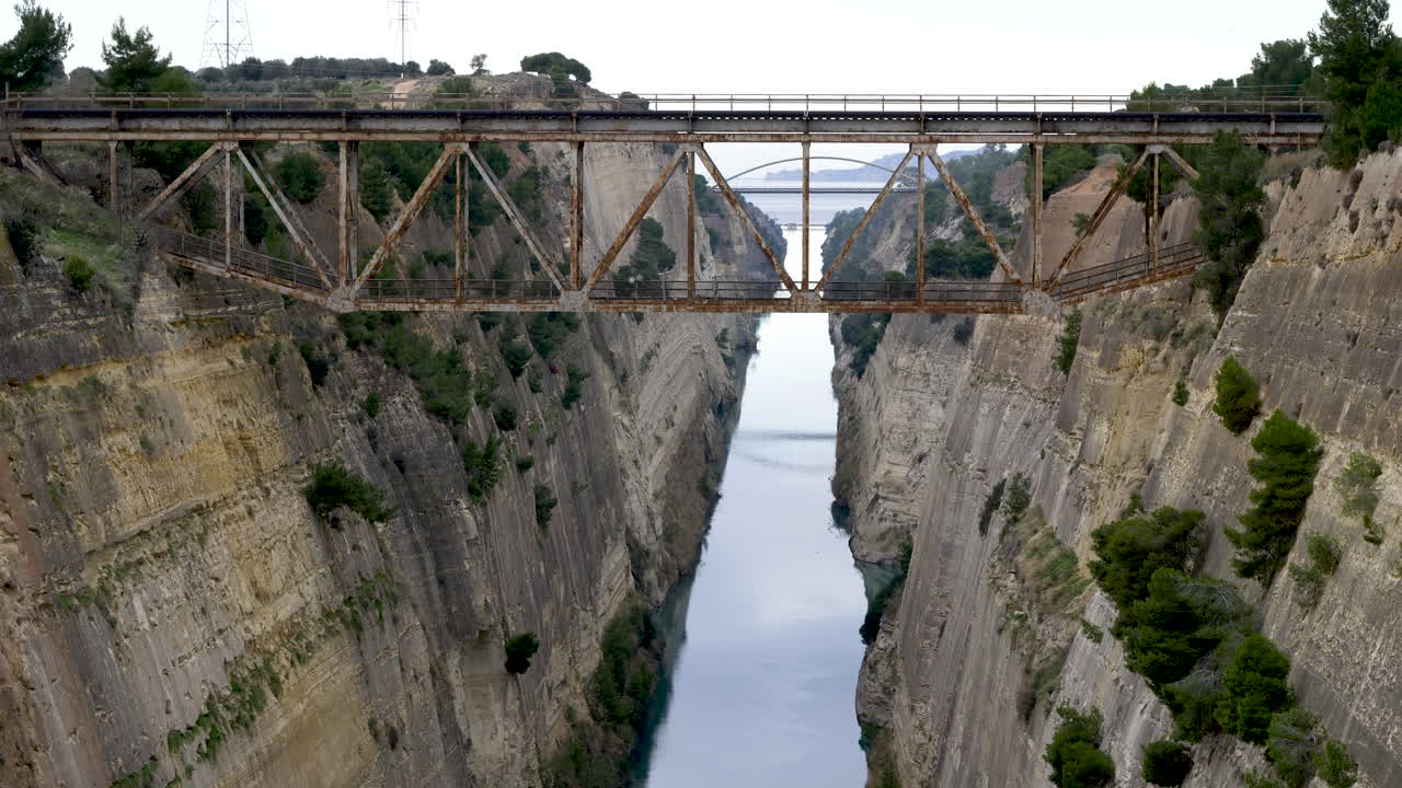 A bridge over the Corinth Canal. It cuts through the narrow Isthmus of Corinth and separates the Peloponnese from the Greek mainland, arguably making the peninsula an island.