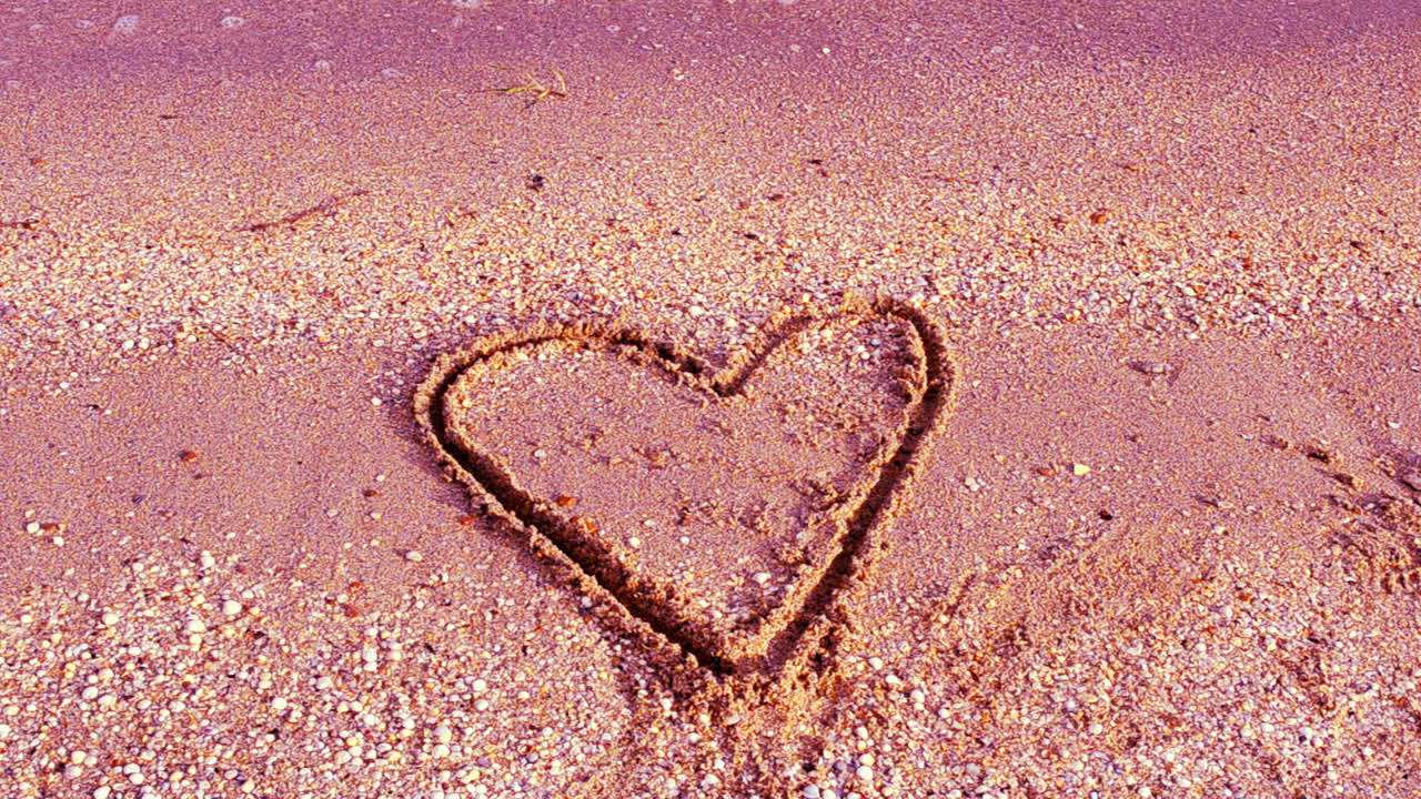 Heart on sand. Shooting on the beach. Shooting on the beach
