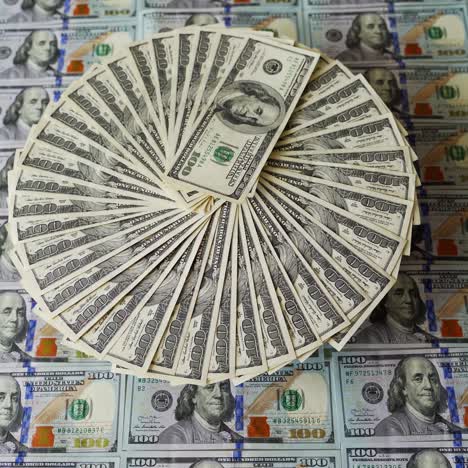 circular arrangement of us hundred-dollar bills