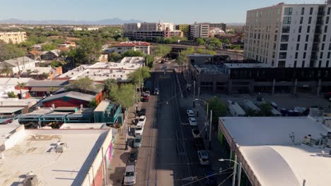aerial view of a city street with buildings and tram tracks