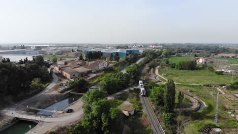 Aerial:-catalan-lands-in-Lleida-province-with-a-little-train-passing-by