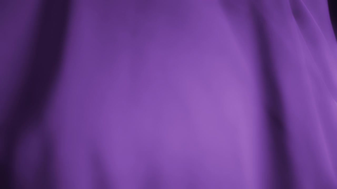 Silky violet chiffon fabric waving in the wind