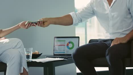 Business-man-counting-money.-Closeup-professional-hands-giving-pack-of-cash