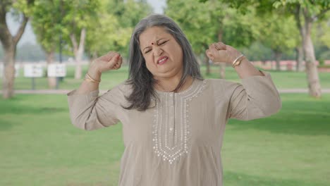 Sleepy-and-tired-Indian-old-woman-yawning-in-park