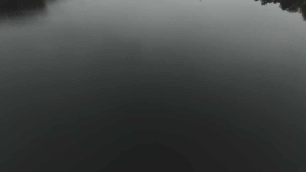 Gyllebo lake in South Sweden, Skåne, Österlen at Autumn with yellow and orange leafs, fog