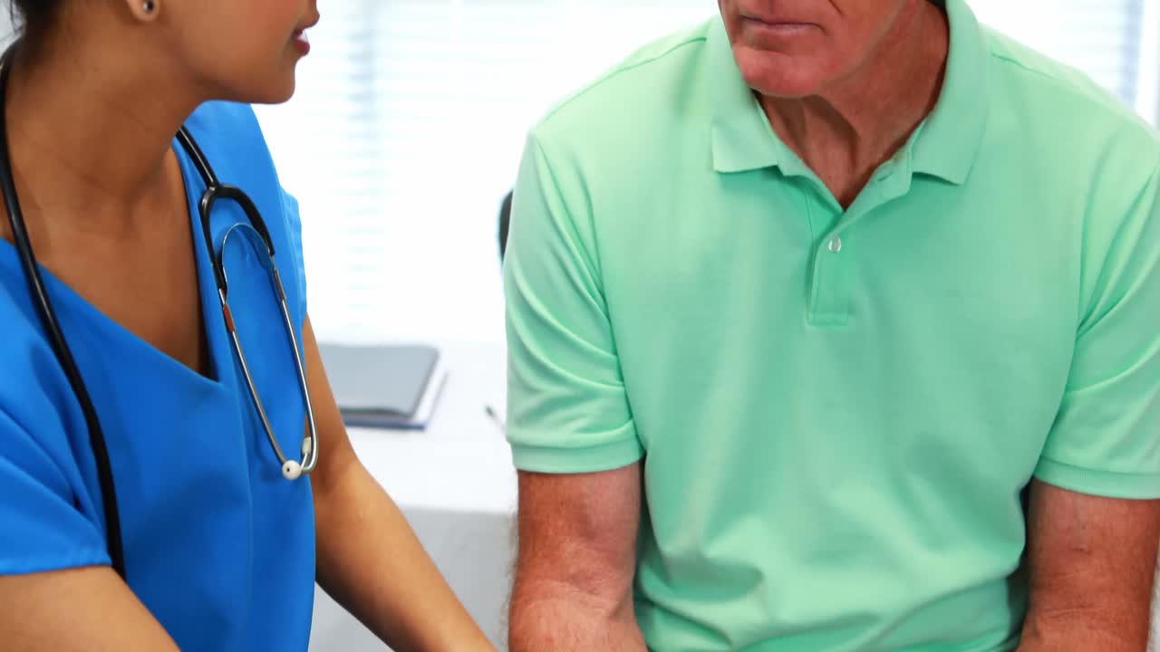 Female doctor comforting senior patient