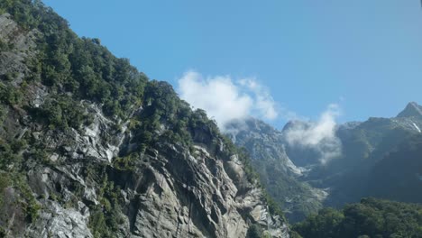 dynamic scene as a mountain gracefully shifts behind a rugged cliff in the mesmerizing landscapes of milford sound