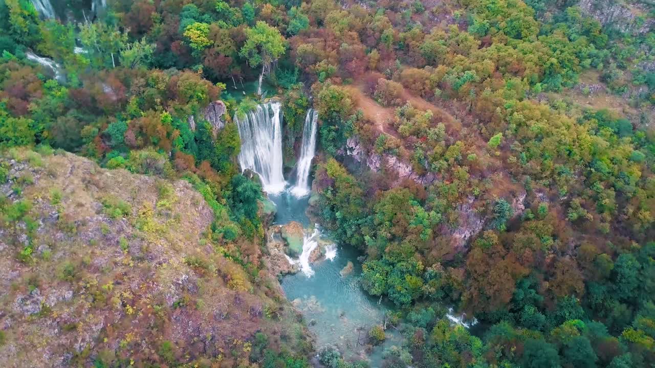 Aerial View of Stunning Waterfall in Lush Autumn Forest