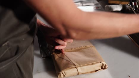 leather craftsman working on knife sheath