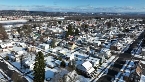 High-aerial-view-of-snow-covered-neighborhood-with-Susquehanna-river-and-Williamsport-Pennsylvania-in-background
