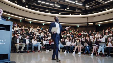 businessman presenting to students in auditorium