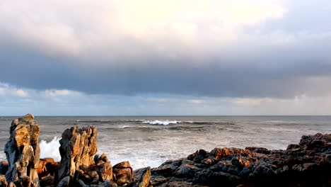 crashing wave atlantic sea water sprays over rugged coastal rocks in slow motion