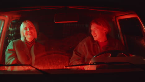 cheerful couple chatting and laughing in car