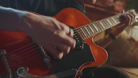 person playing a vintage red guitar