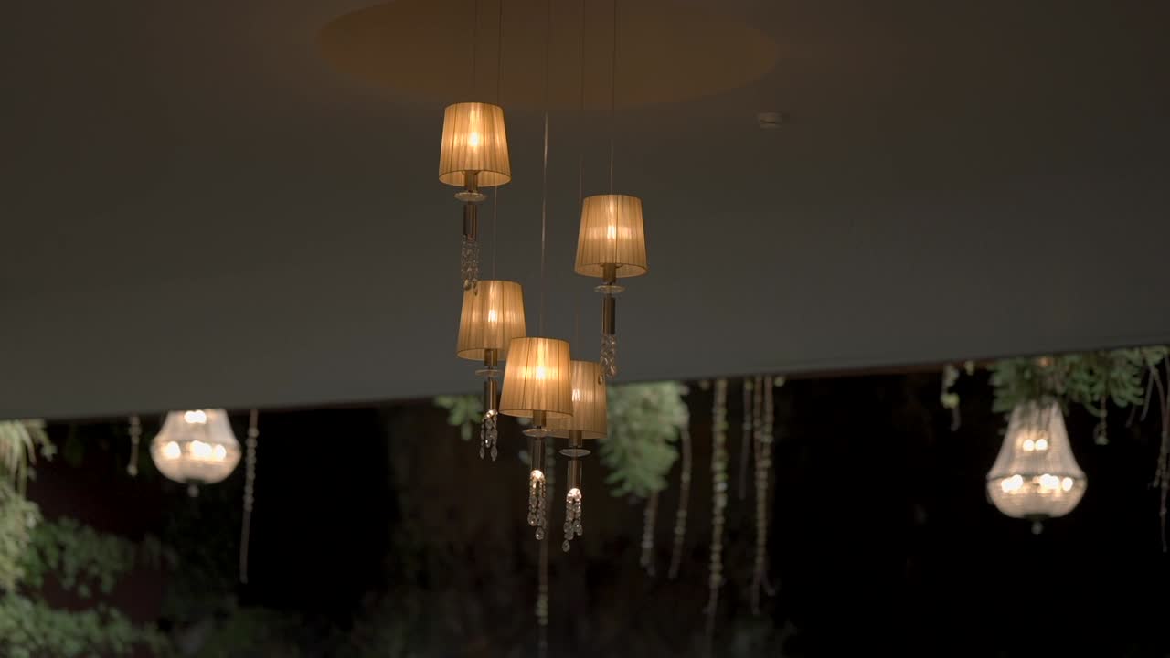 Warm glowing pendant lights in a modern arrangement, adding a sophisticated ambiance to the space