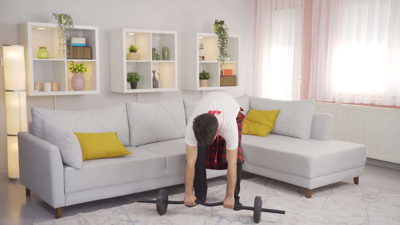 Funny man working muscle can't lift the weight.