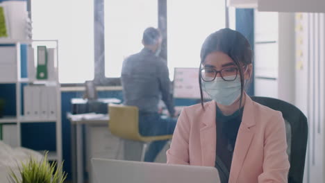 portrait of entrepreneur woman wearing face mask to avoid infection with coronavirus