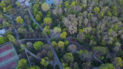 city park with tennis courts and pond, aerial view high angle