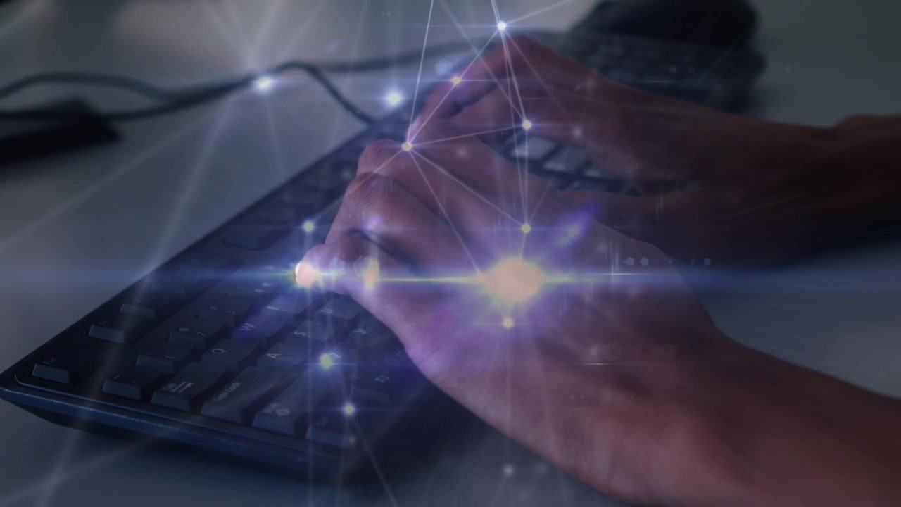 Glowing network of connections against mid section of a person typing on keyboard