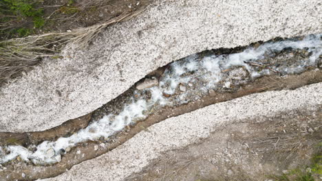 curved glacial mountain stream running from provo, utah ice caves, aerial view from above