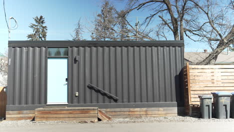 shipping container house in a back alley