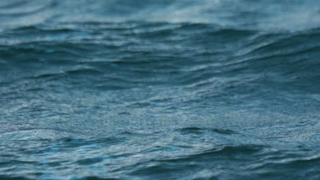 slow motion close up view of blue waves in rough ocean